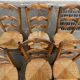 6 solid wood chairs with straw seats and butterfly carved backs.