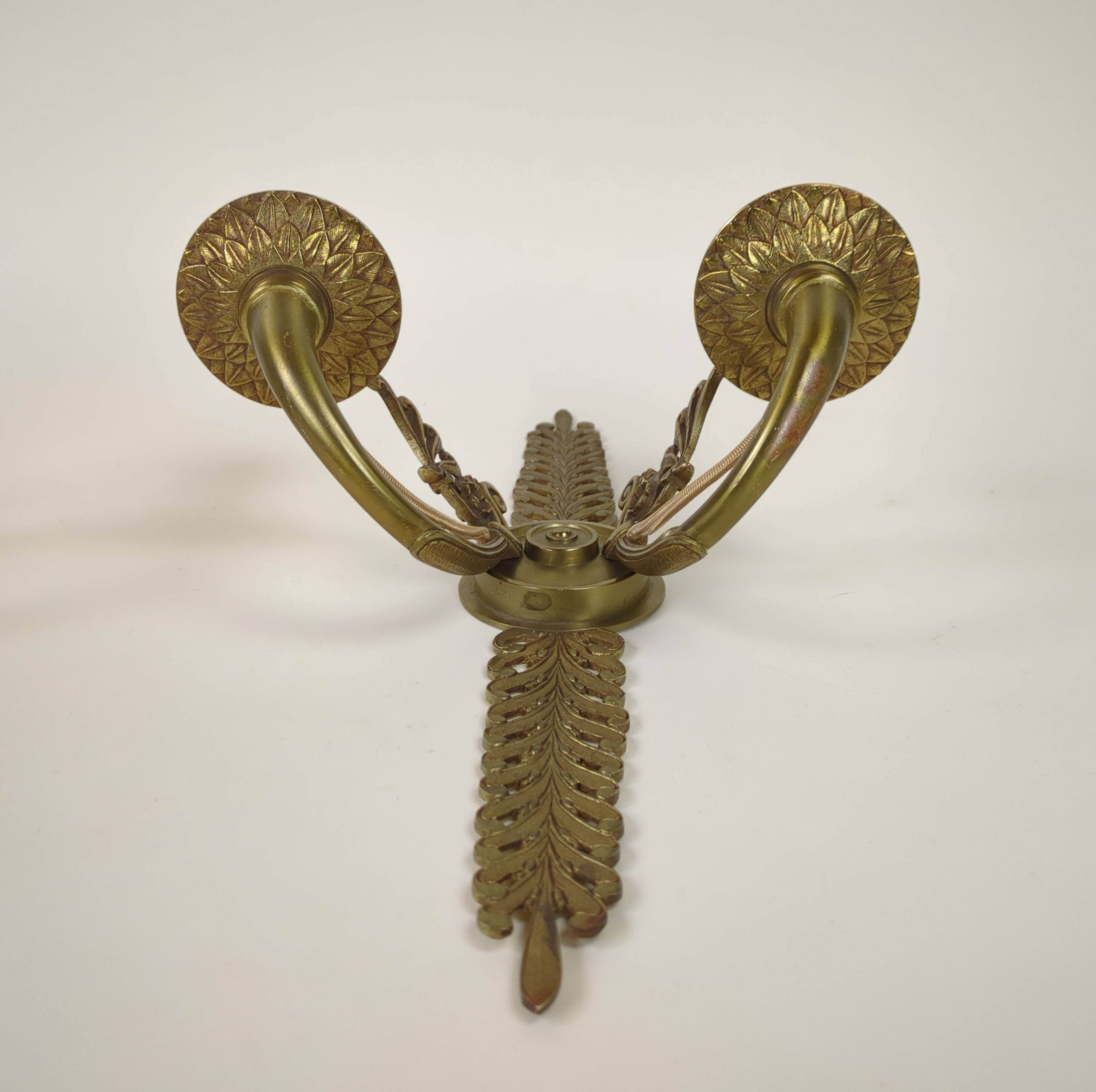 Pair of two-armed Empire wall sconces in gilded bronze