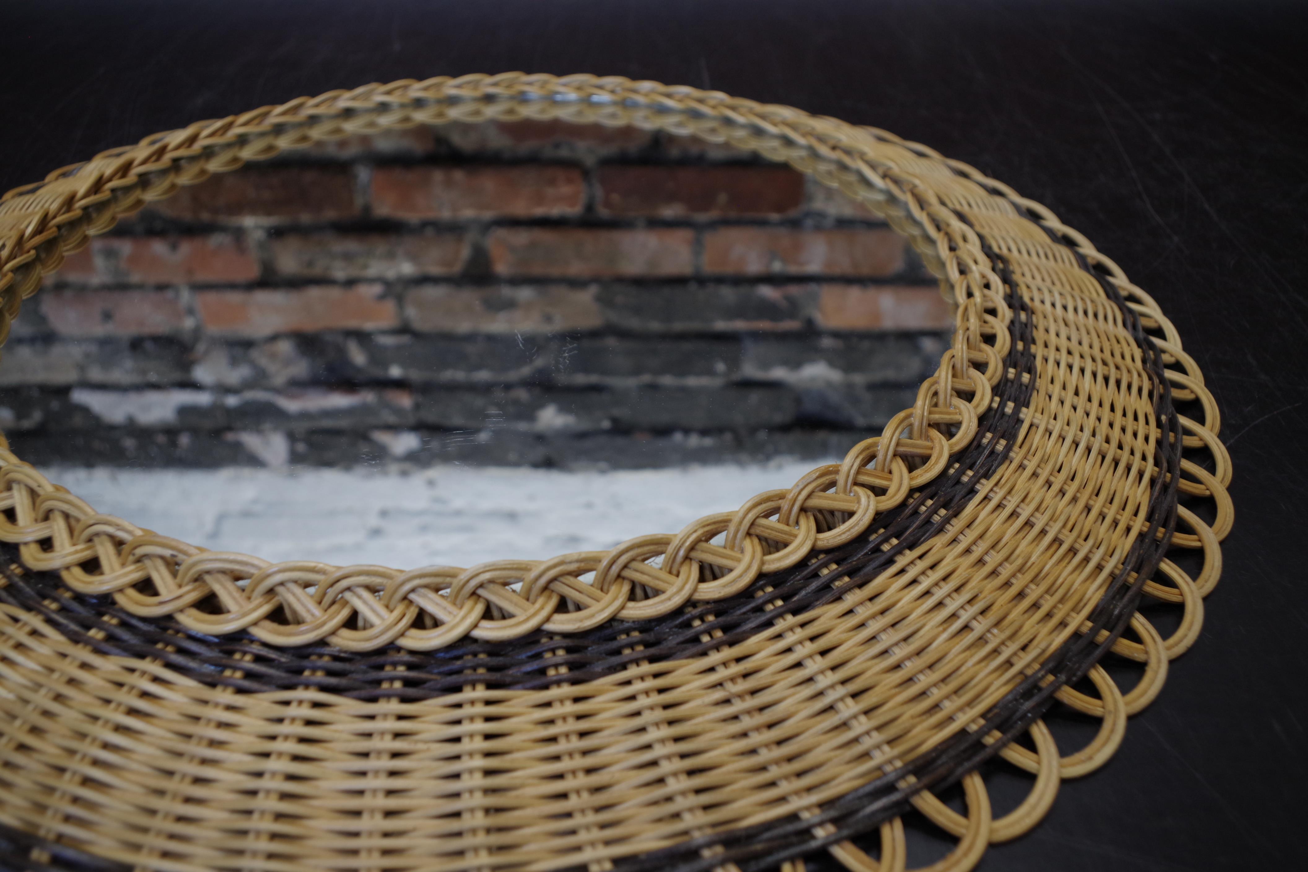 Vintage round mirror in a wicker frame