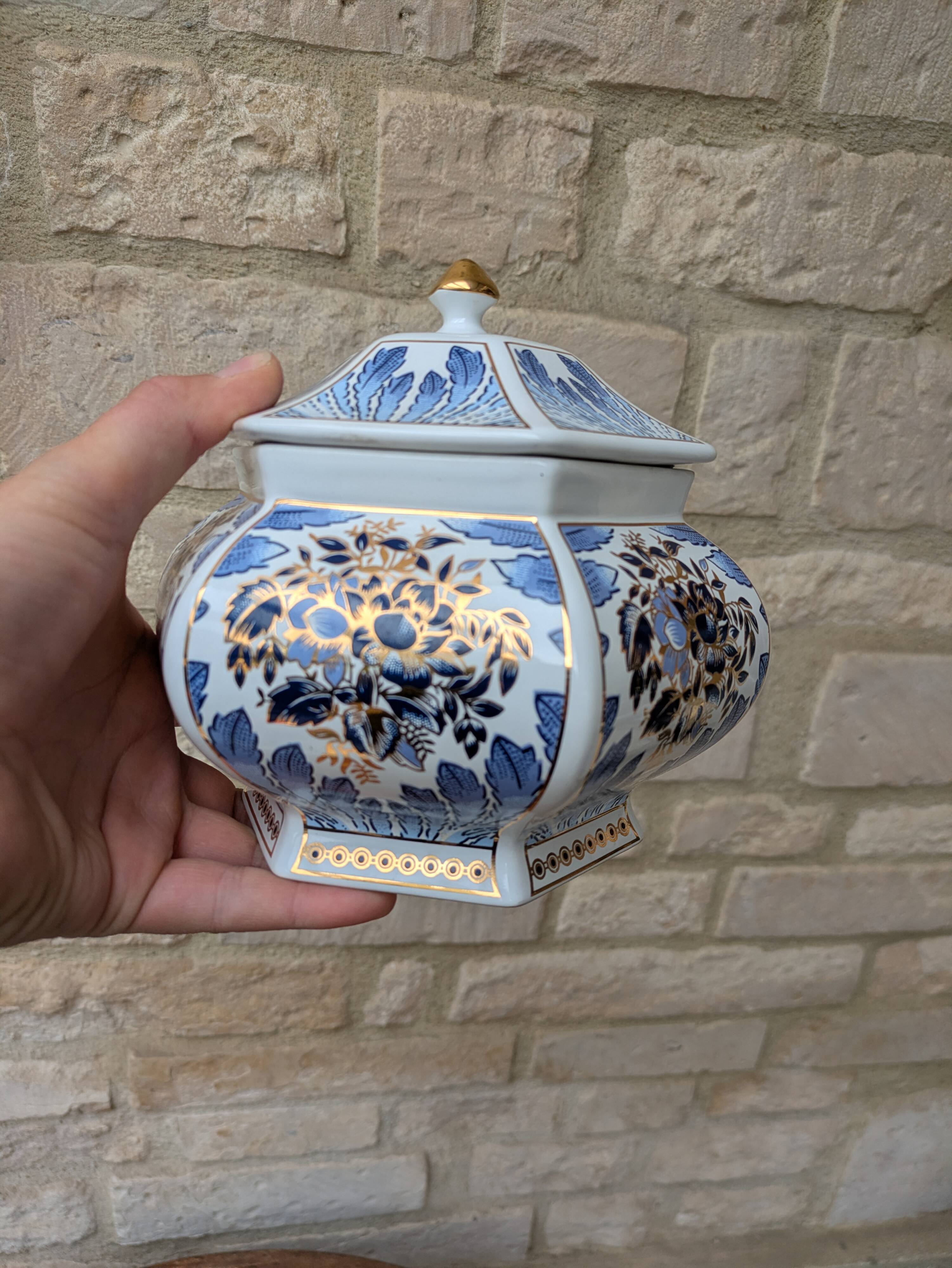 Decorative pot jar with a lid featuring a blue floral pattern and gilding.