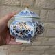Decorative pot jar with a lid featuring a blue floral pattern and gilding.