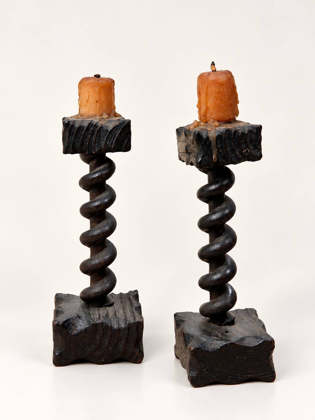 Charming pair of antique turned wooden candlesticks, featuring a beautiful p
