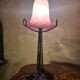 Antique wrought iron floor lamp, 1900, with a glass shade, 40x15.
