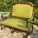 Richly carved solid wood bench in Louis XVI style.
