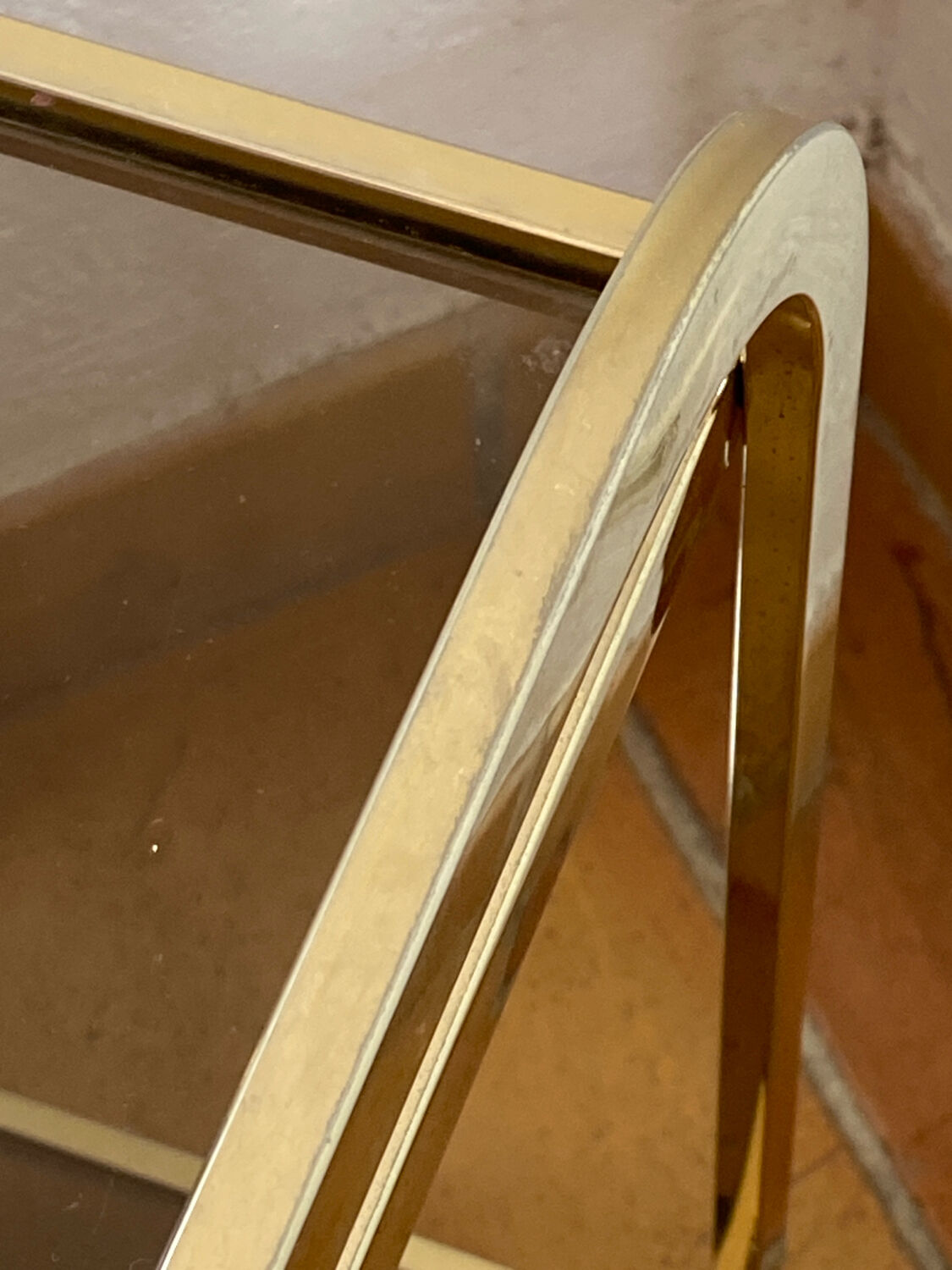 Gold metal and smoked glass console table.