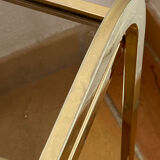Gold metal and smoked glass console table.