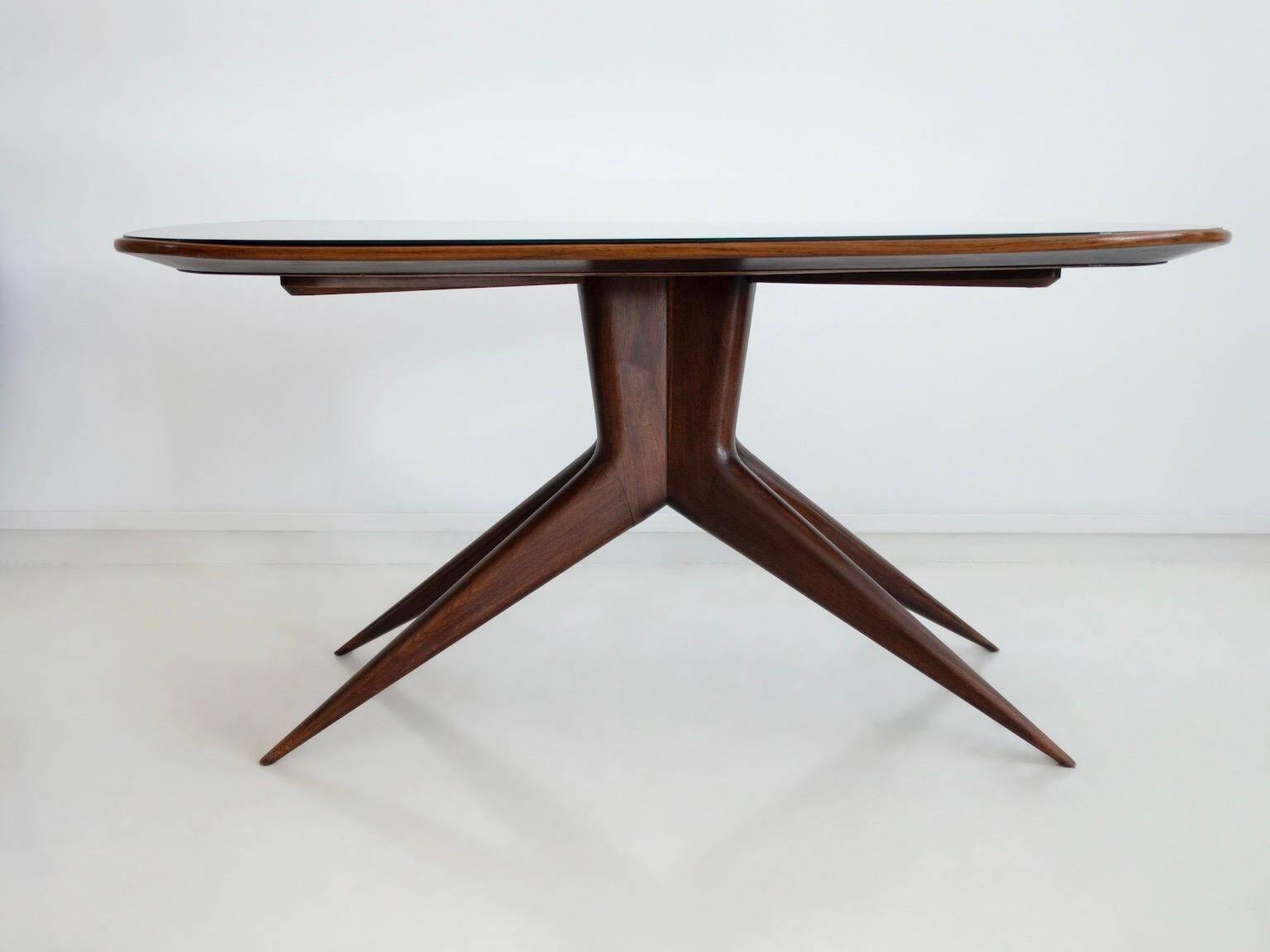 Dining table with a wooden frame and tinted glass top.