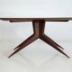 Dining table with a wooden frame and tinted glass top.