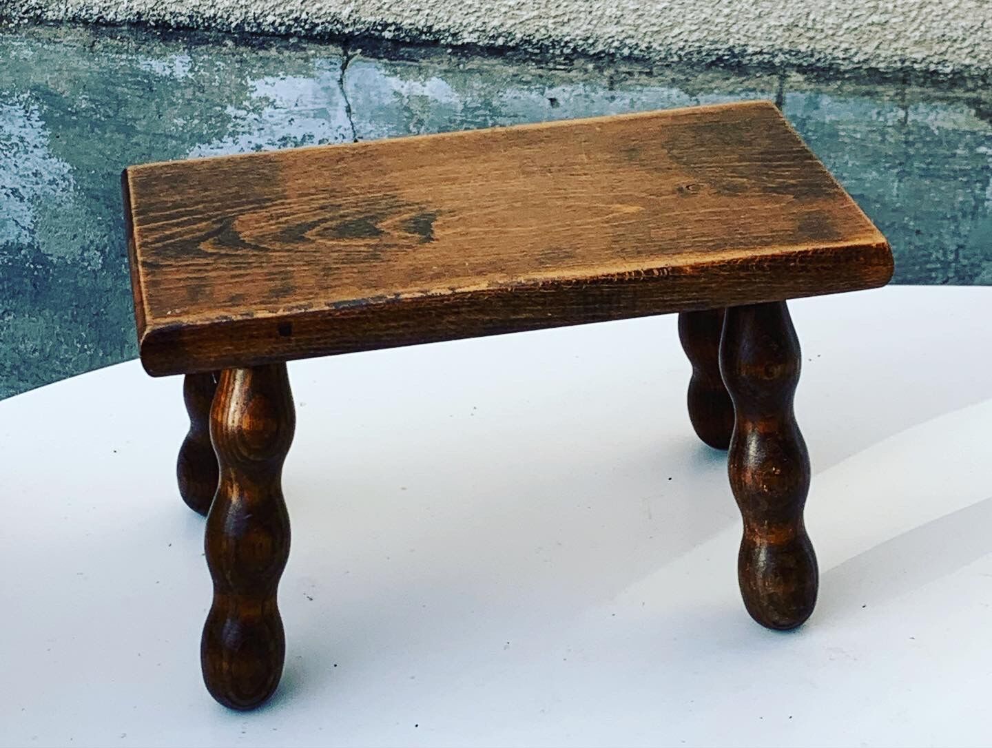 Footstool in varnished wood turns old