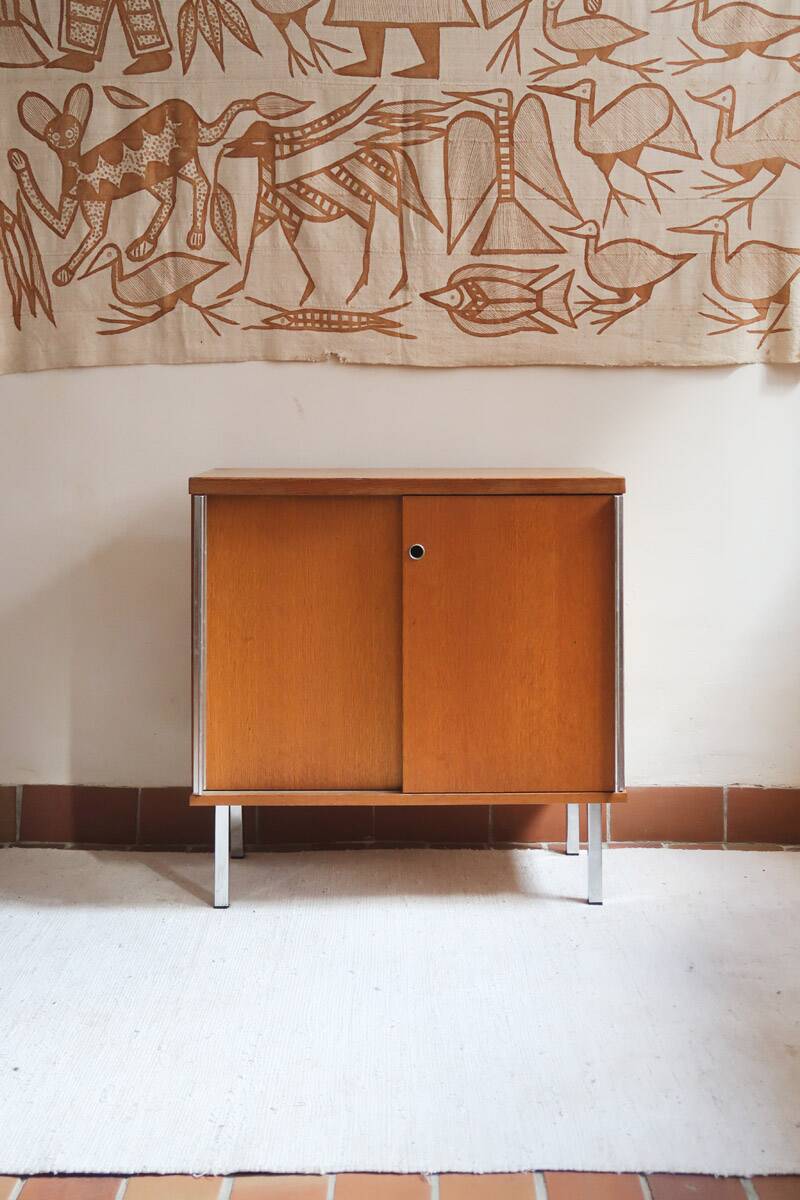 1970s low furniture in wood and metal with sliding doors.