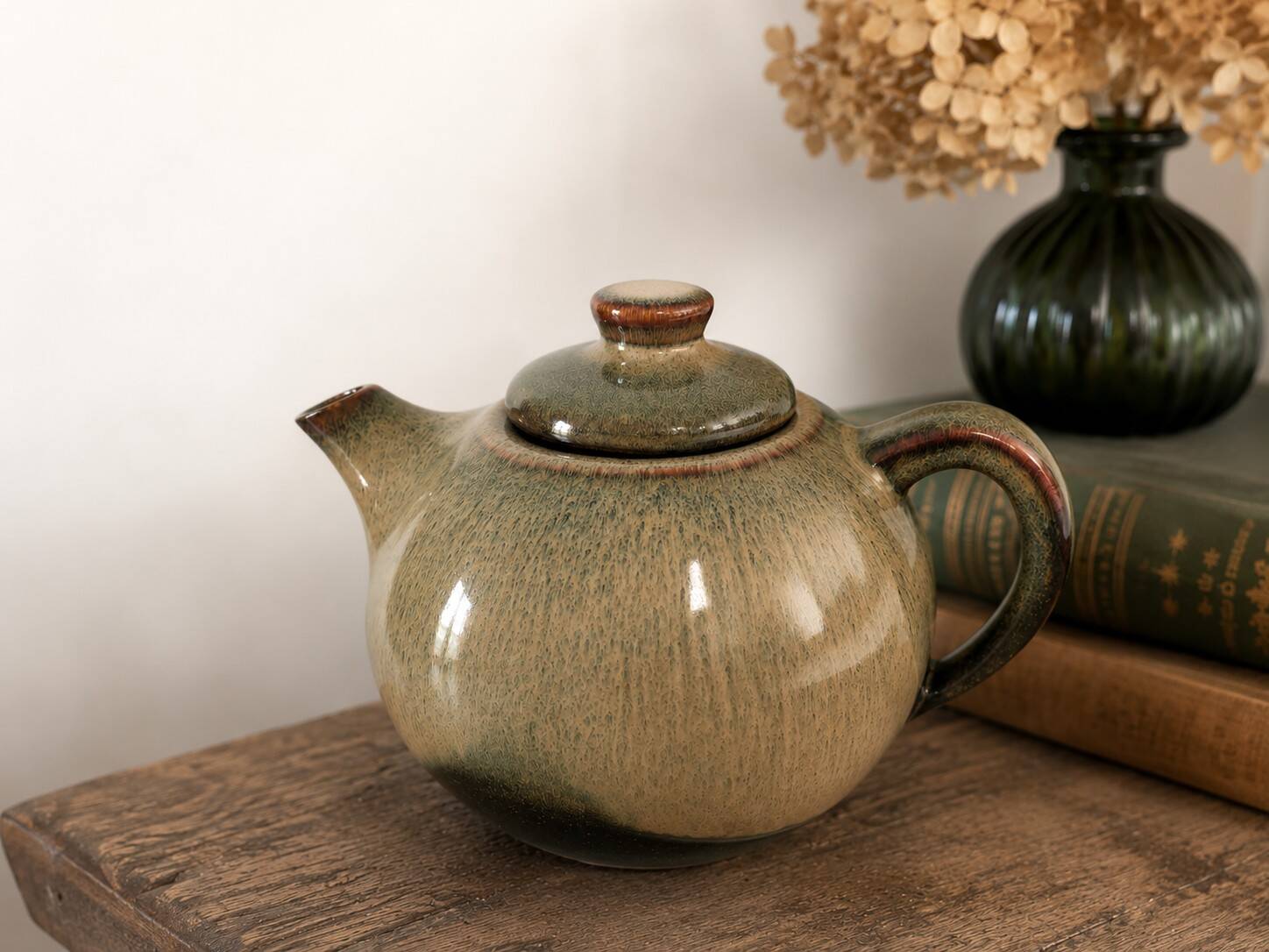 Vintage ceramic teapot with a flame design.