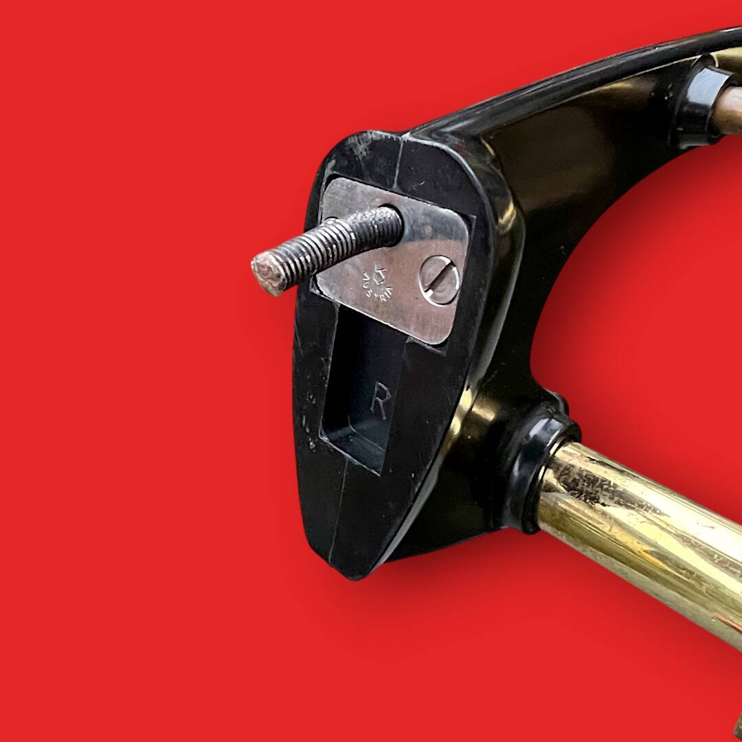 Vintage wall-mounted coat rack in black bakelite and brass – 1950s