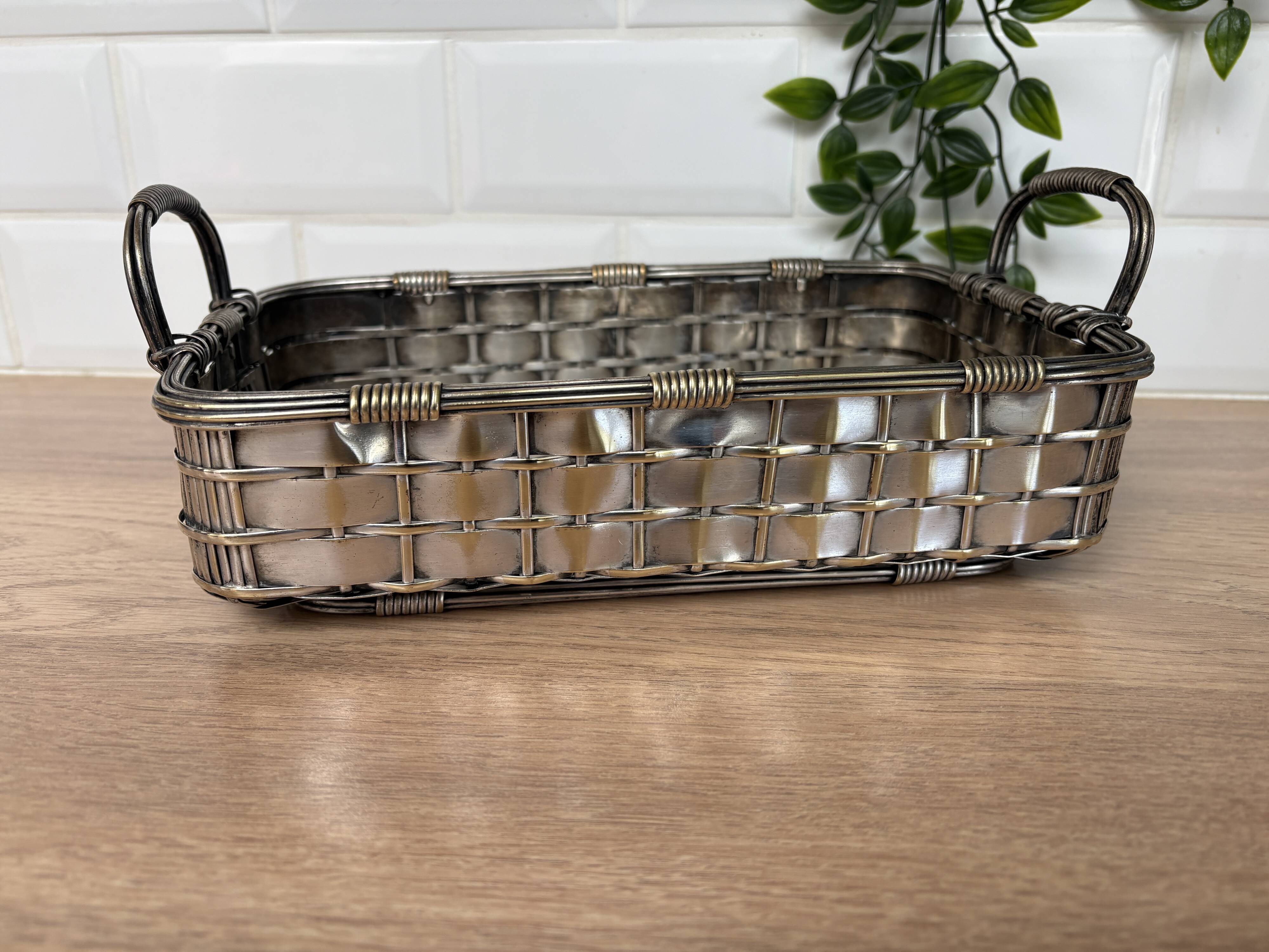 Woven silver-plated metal basket.
