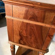 Antique wooden bedside table with turned legs.
