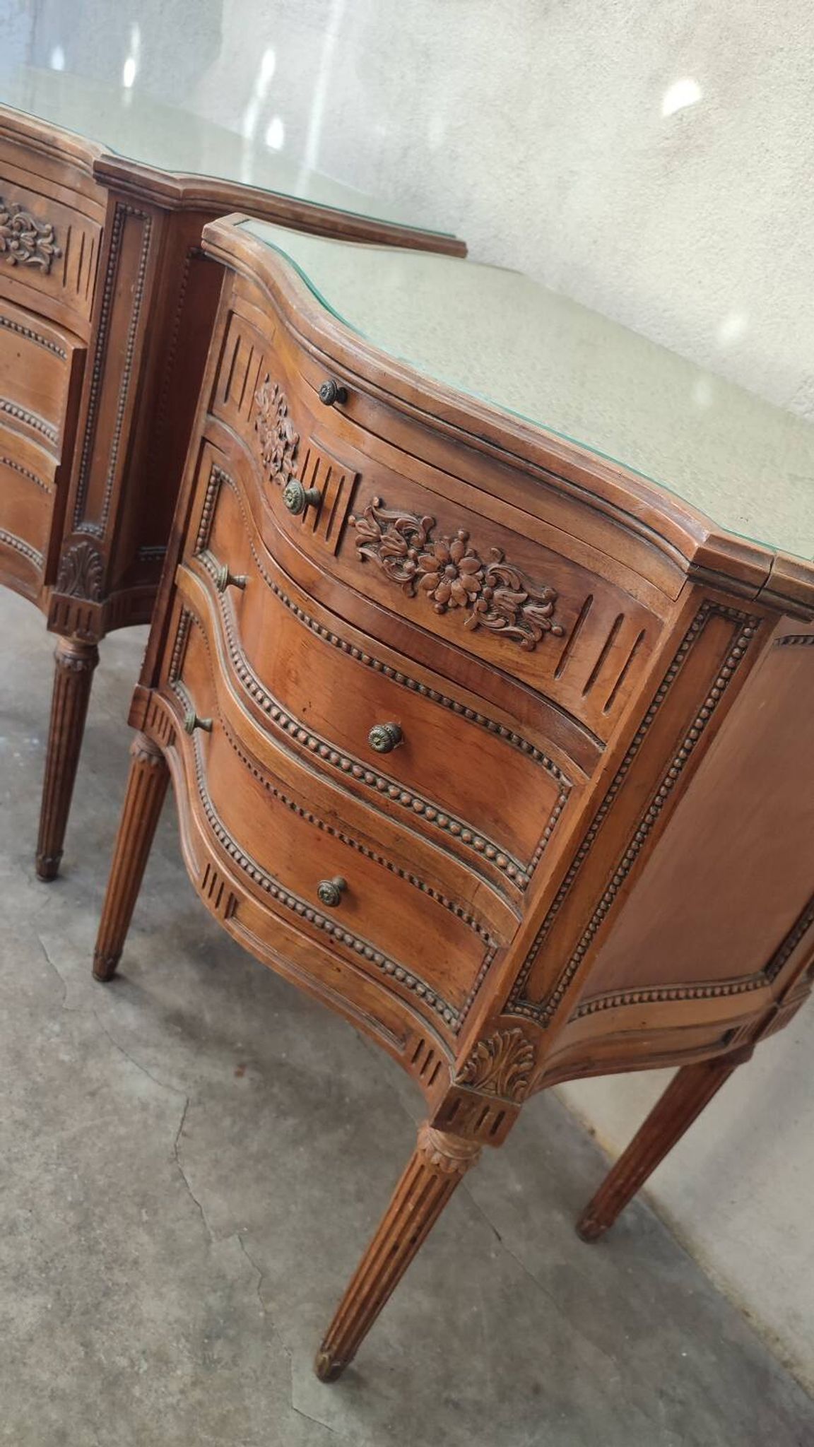 Pair of bow-fronted chests of drawers in walnut