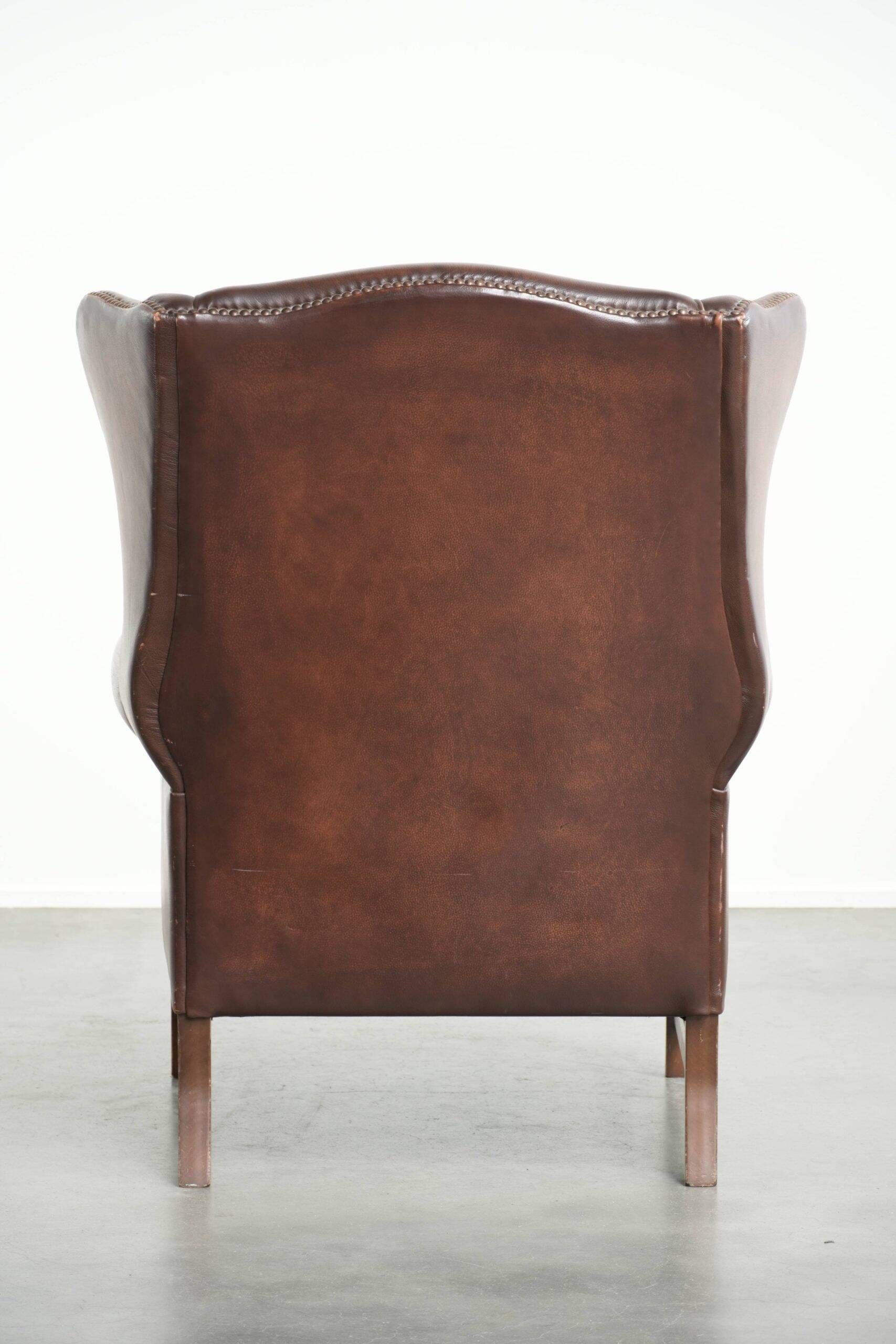 Comfortable cowhide wingback armchair in English style with a timeless look