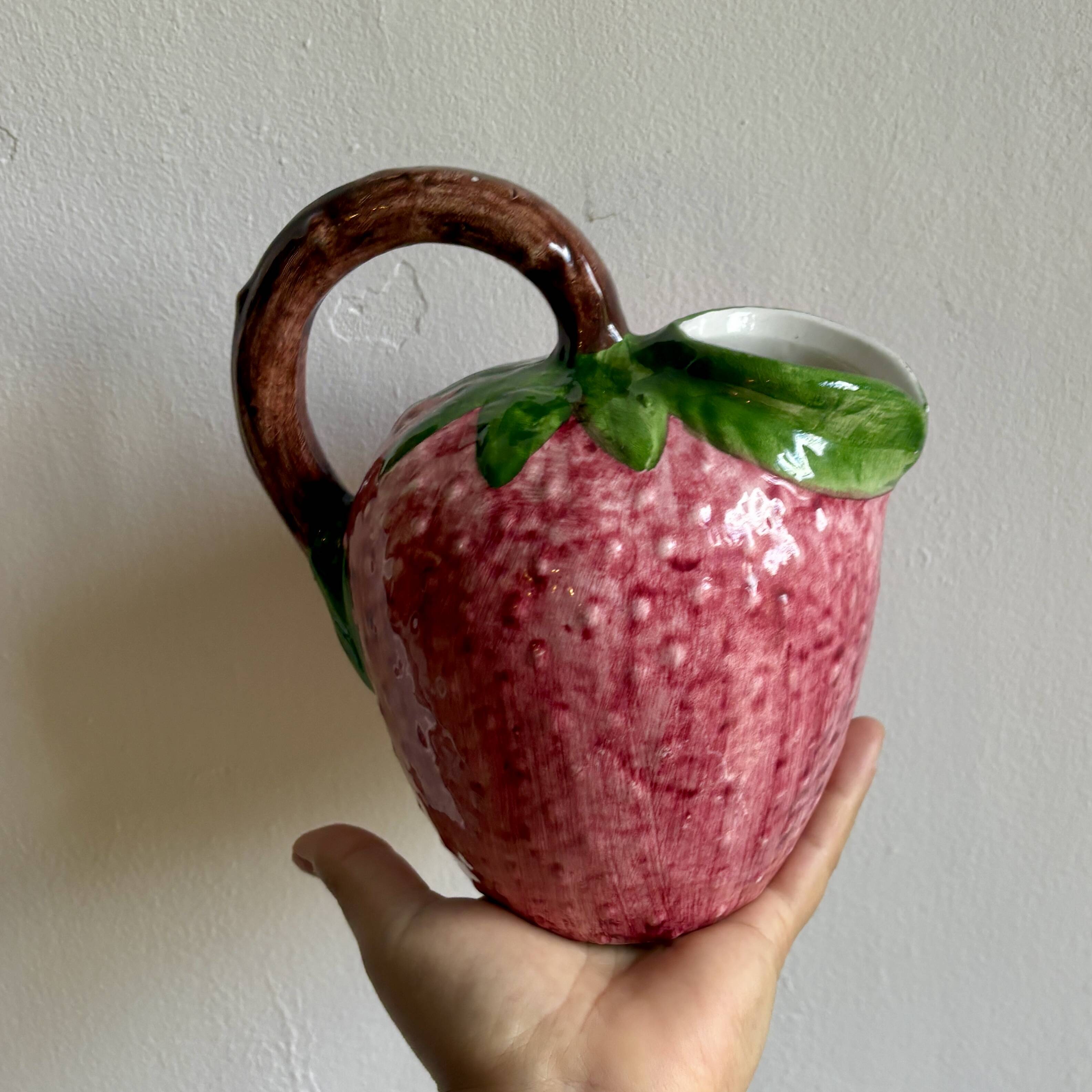 Ceramic jug in the shape of a strawberry.
