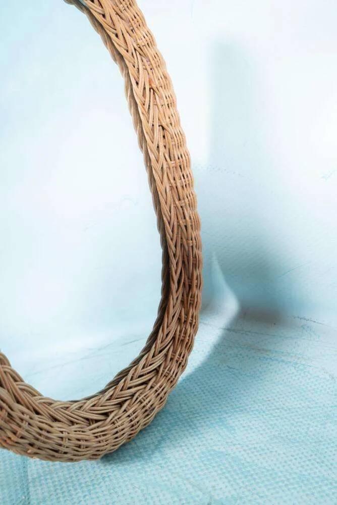 Vintage 70s bohemian wall mirror in woven rattan.