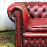 Pair of red leather chesterfield chairs