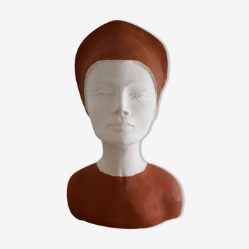 Bust of a woman in plaster terracotta and white color