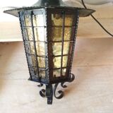 Large hanging lantern in wrought iron and opaque yellow-orange windows
