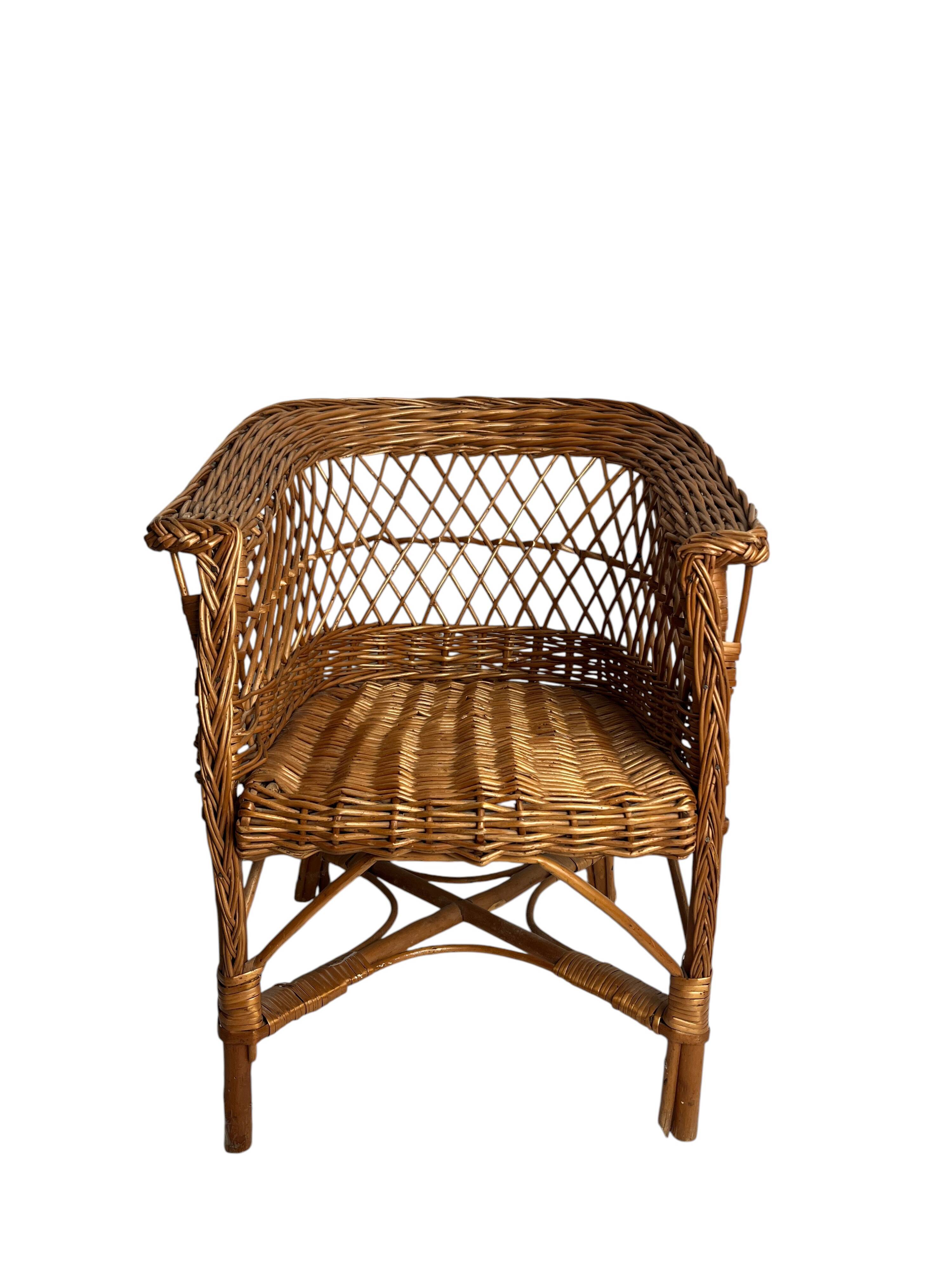 Vintage, children's armchair in woven rattan from around 1970.