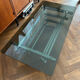 70s design coffee table in rectangular glass with chrome legs.