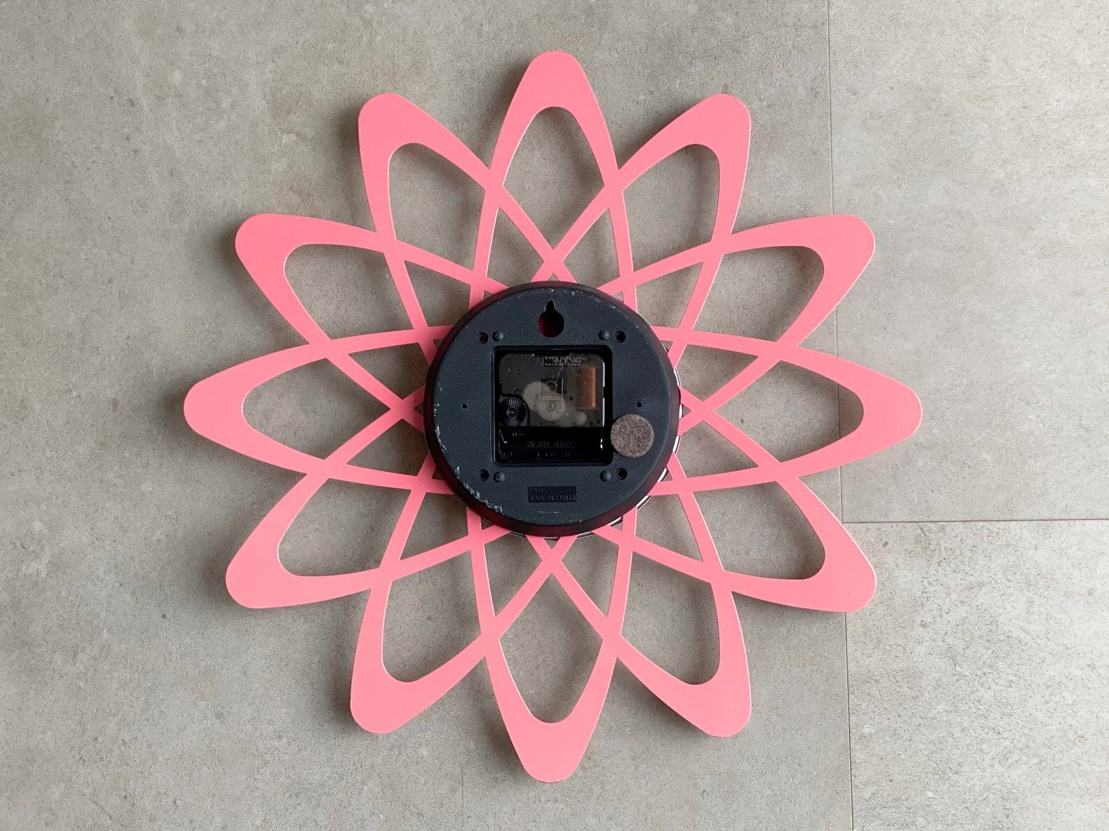 Pink Karlsson wall clock in a mid century shape