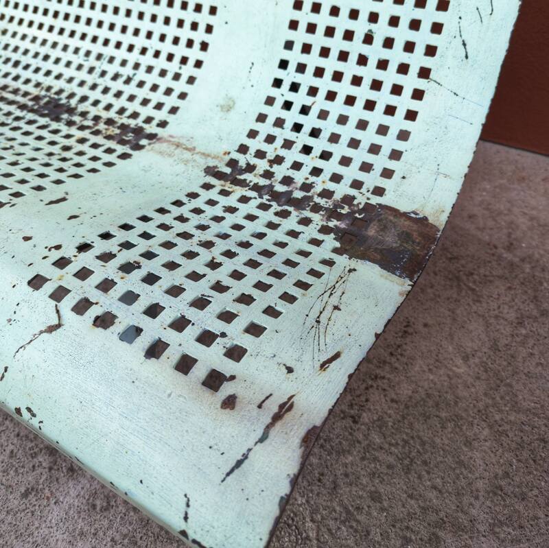 Public bench made of perforated iron