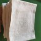 12 damask linen table napkins with an antique silk monogram from the 19th century.