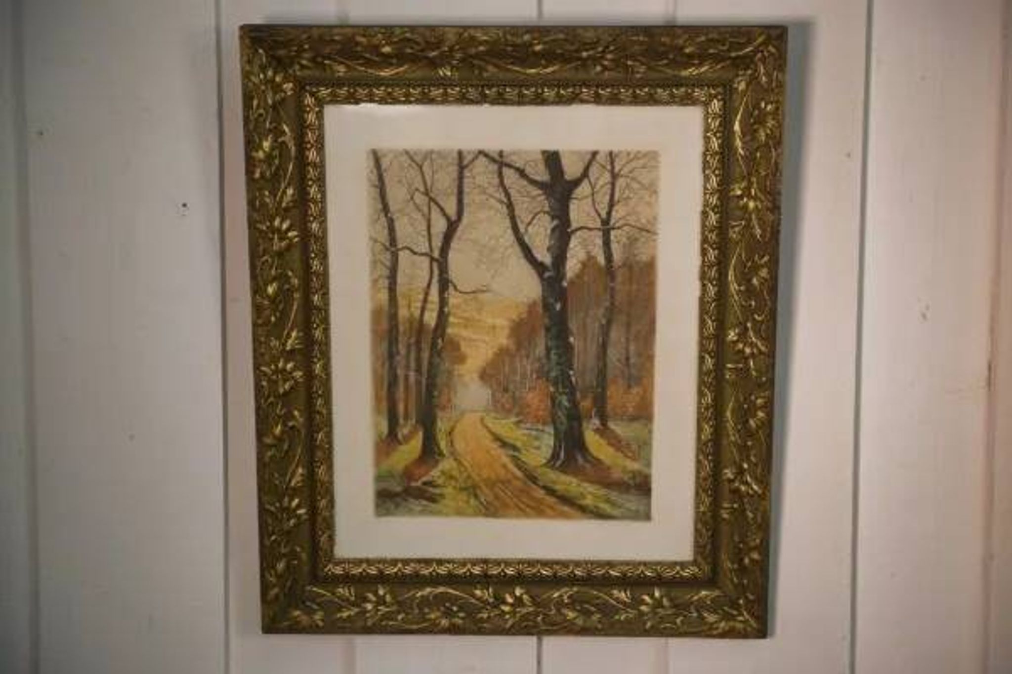 Lithograph of a woodland path, gilt frame, with embossed foliage decoration, 1950s
