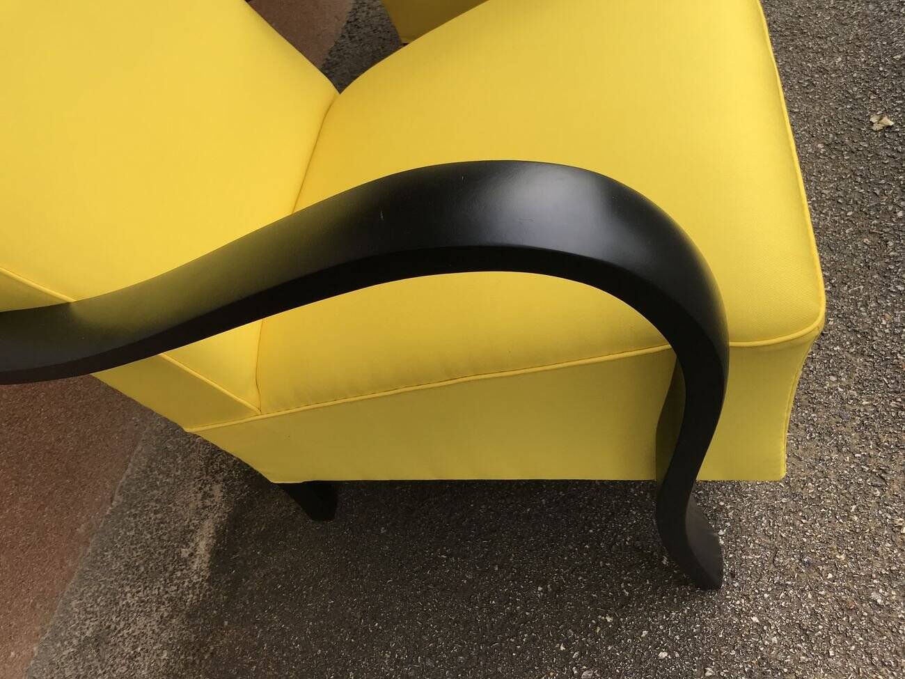 Pair of yellow Art Deco armchairs in cotton and wood, black frame, 1920s.