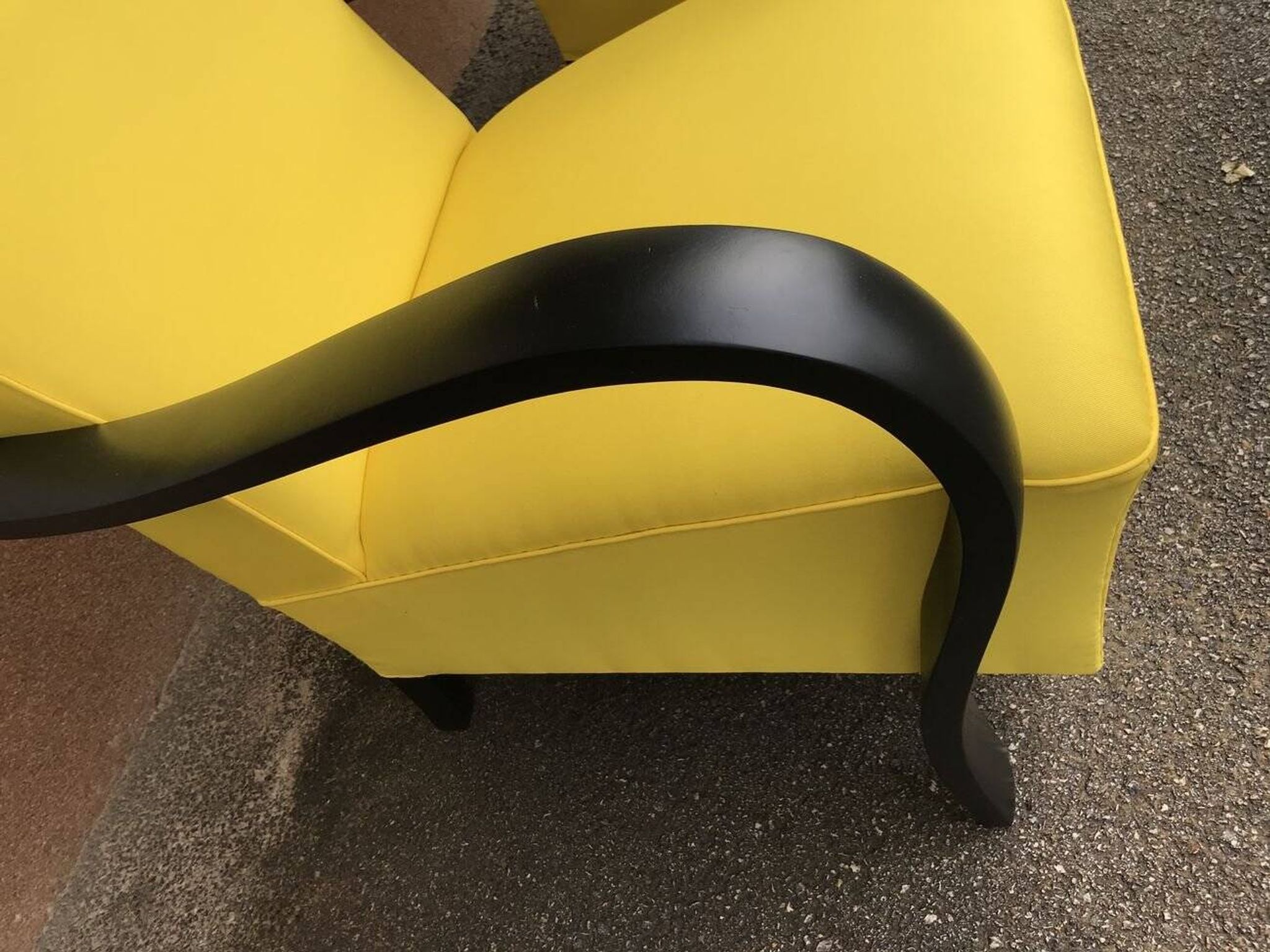 Pair of yellow Art Deco armchairs in cotton and wood, black frame, 1920s.
