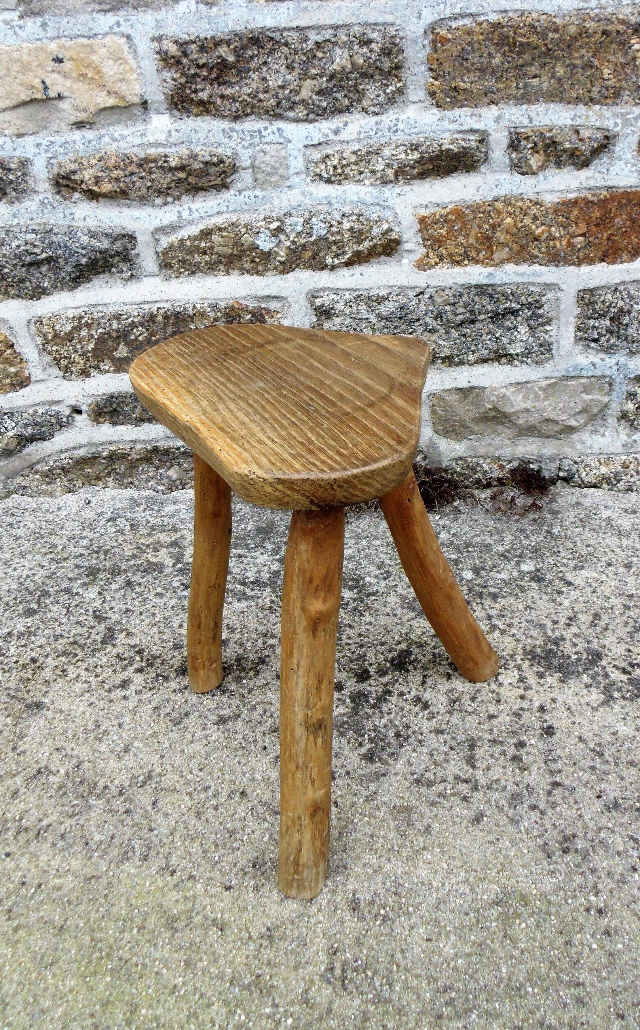 Farm stool in raw wooden sitting in the shape of a popular art