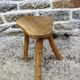 Farm stool in raw wooden sitting in the shape of a popular art
