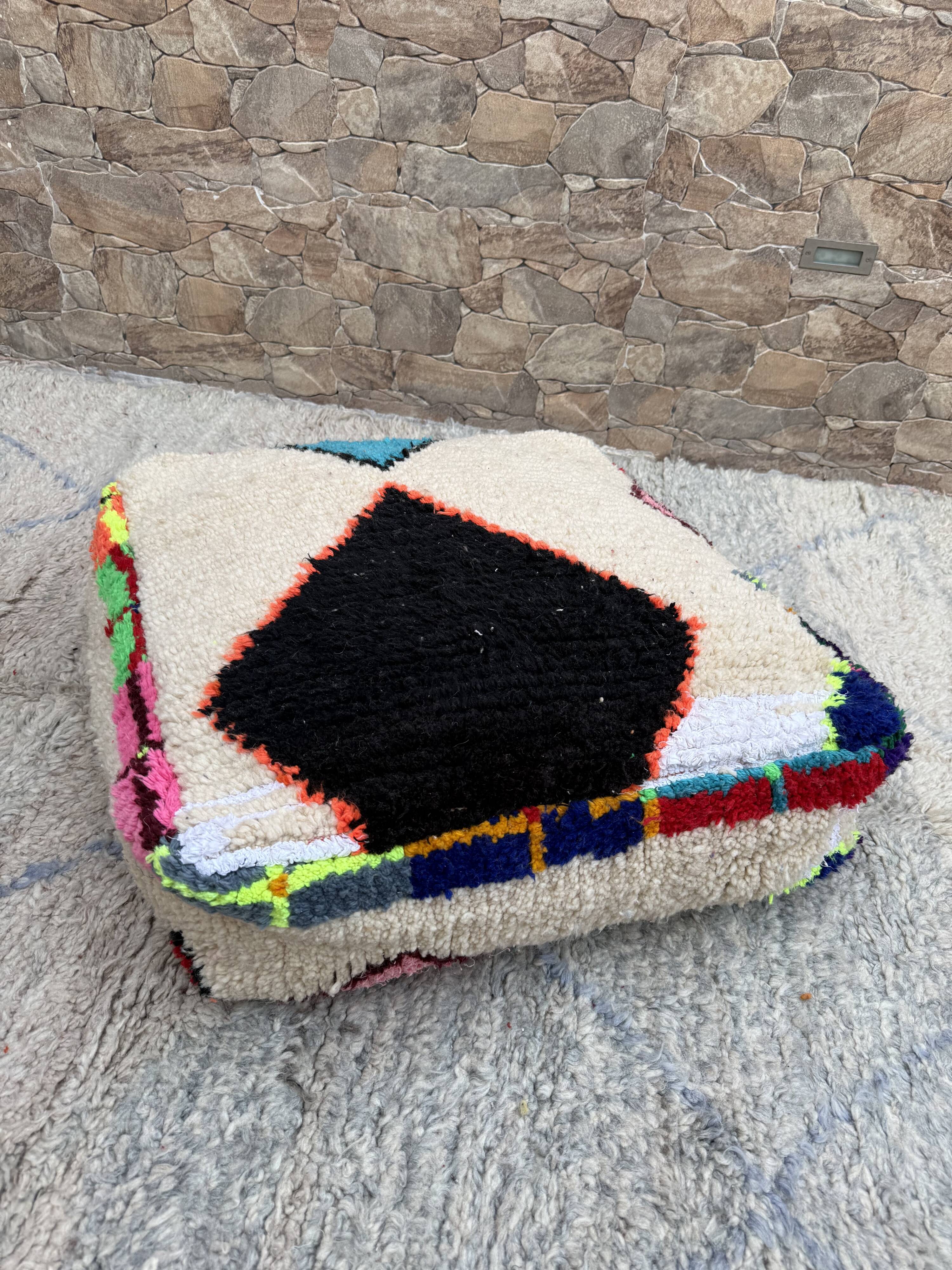 Berber floor pouf: Handwoven Moroccan wool cushion.