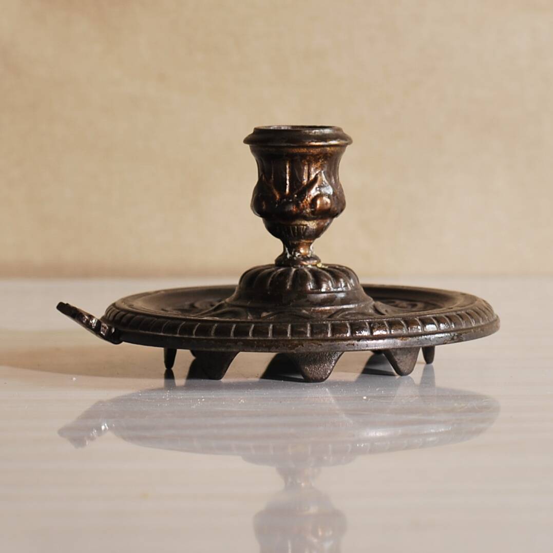 Bronze cellar rat hand candle holder