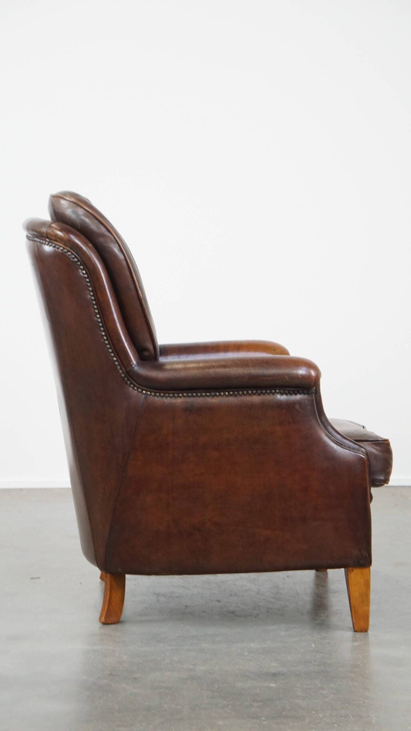 Vintage sheepskin armchair in a dark cognac colour with a comfortable seat