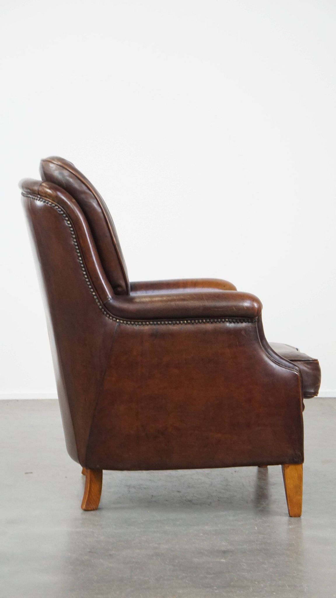 Vintage sheepskin armchair in a dark cognac colour with a comfortable seat