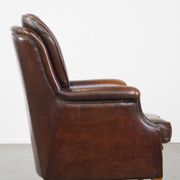 Vintage sheepskin armchair in a dark cognac colour with a comfortable seat