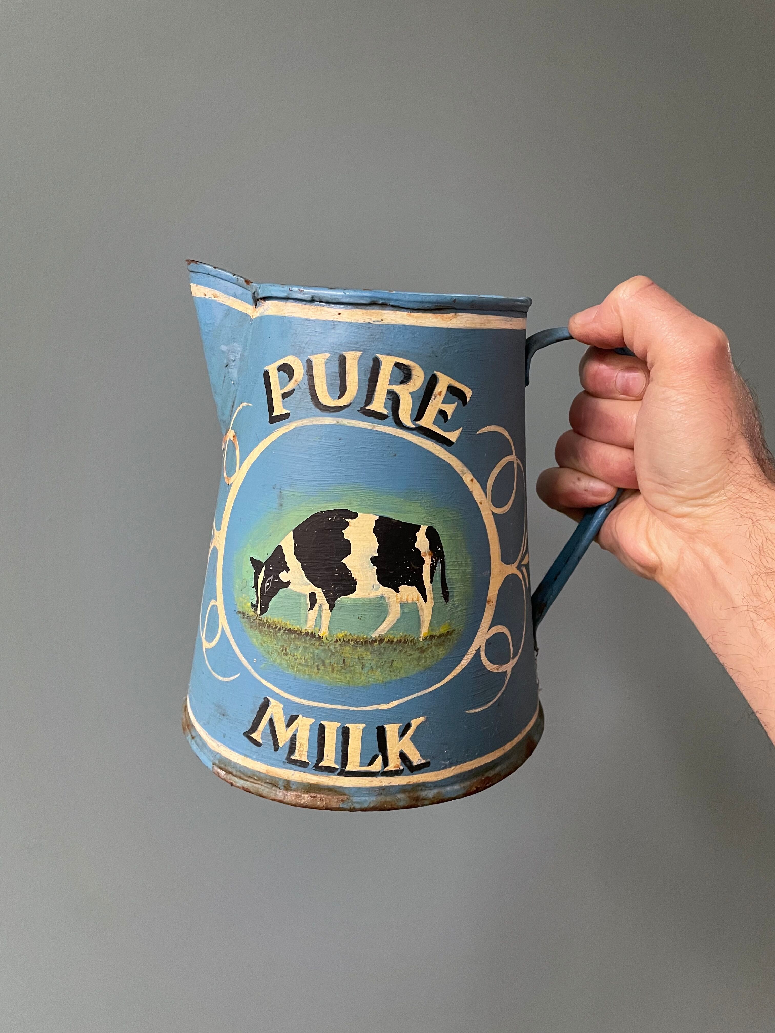 Old painted sheet metal jug or milk jug