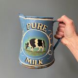 Old pitcher or milk jug in painted sheet metal
