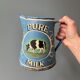 Old painted sheet metal jug or milk jug