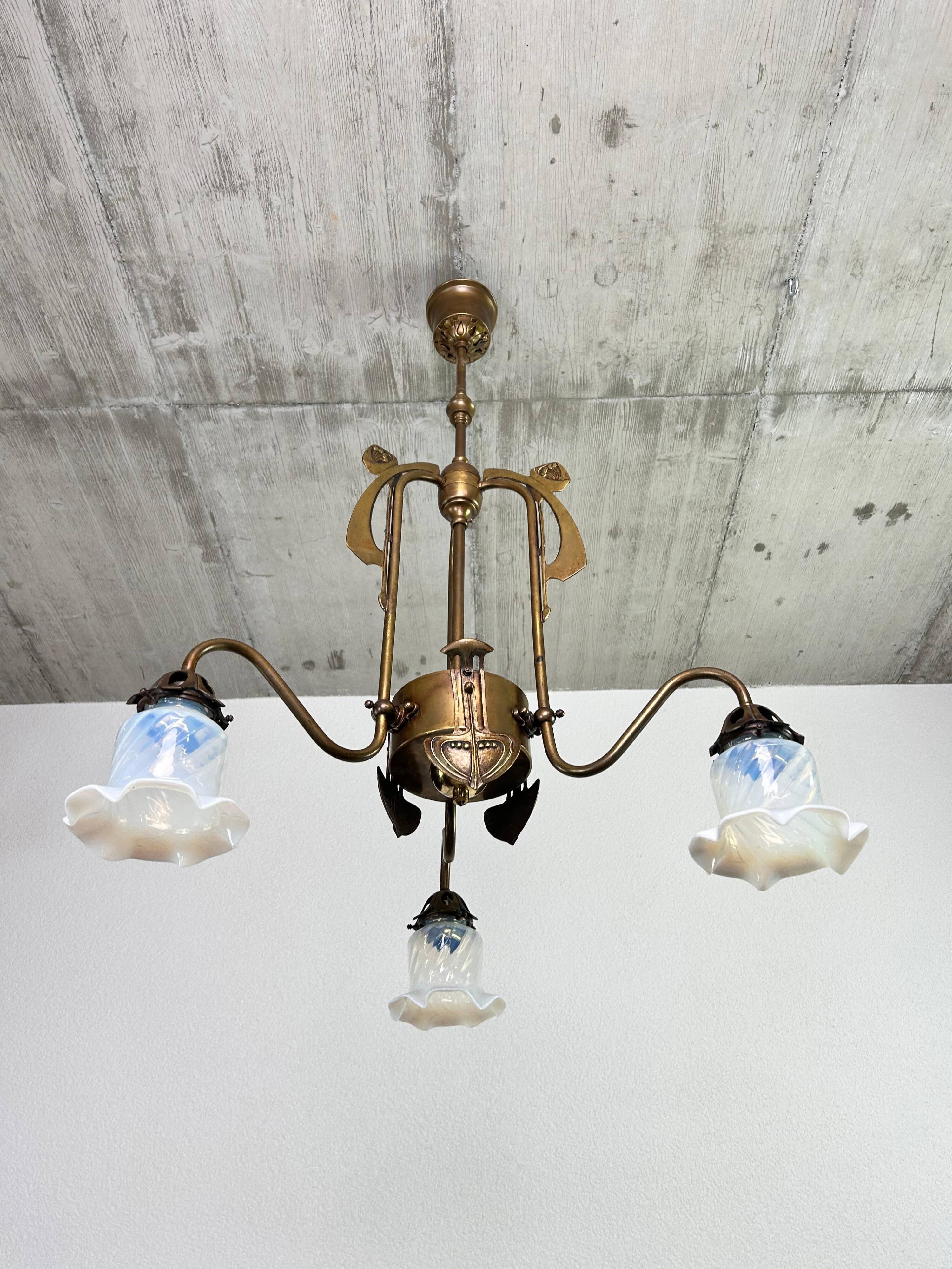Art Nouveau chandelier with three arms and opalescent iridescent glass.