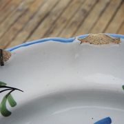 Old earthenware plate with wall support: floral decor