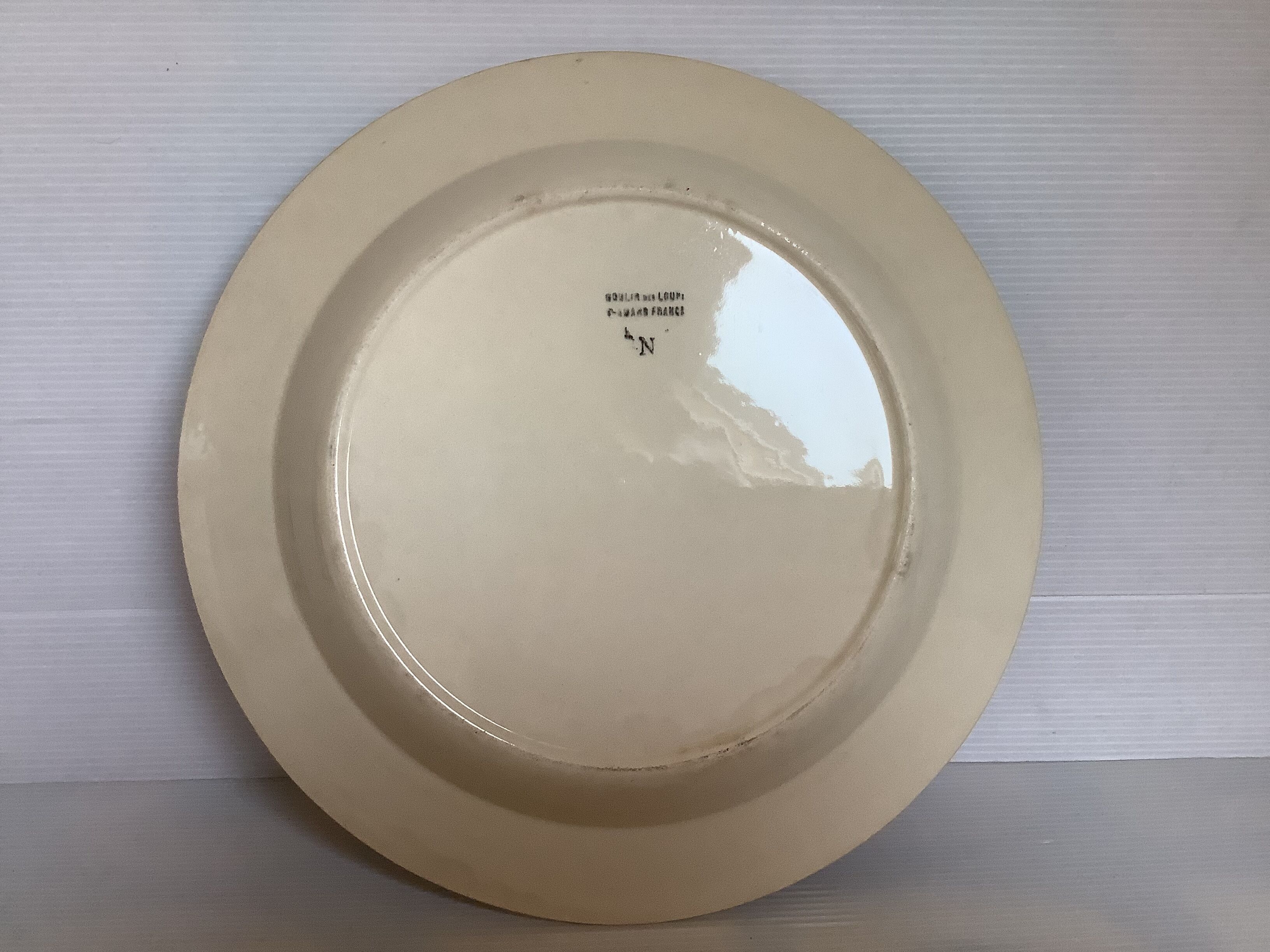 Earthenware plate from Moulin des Loups with stencil pattern.
