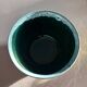 Green cache pot with a foam trim.