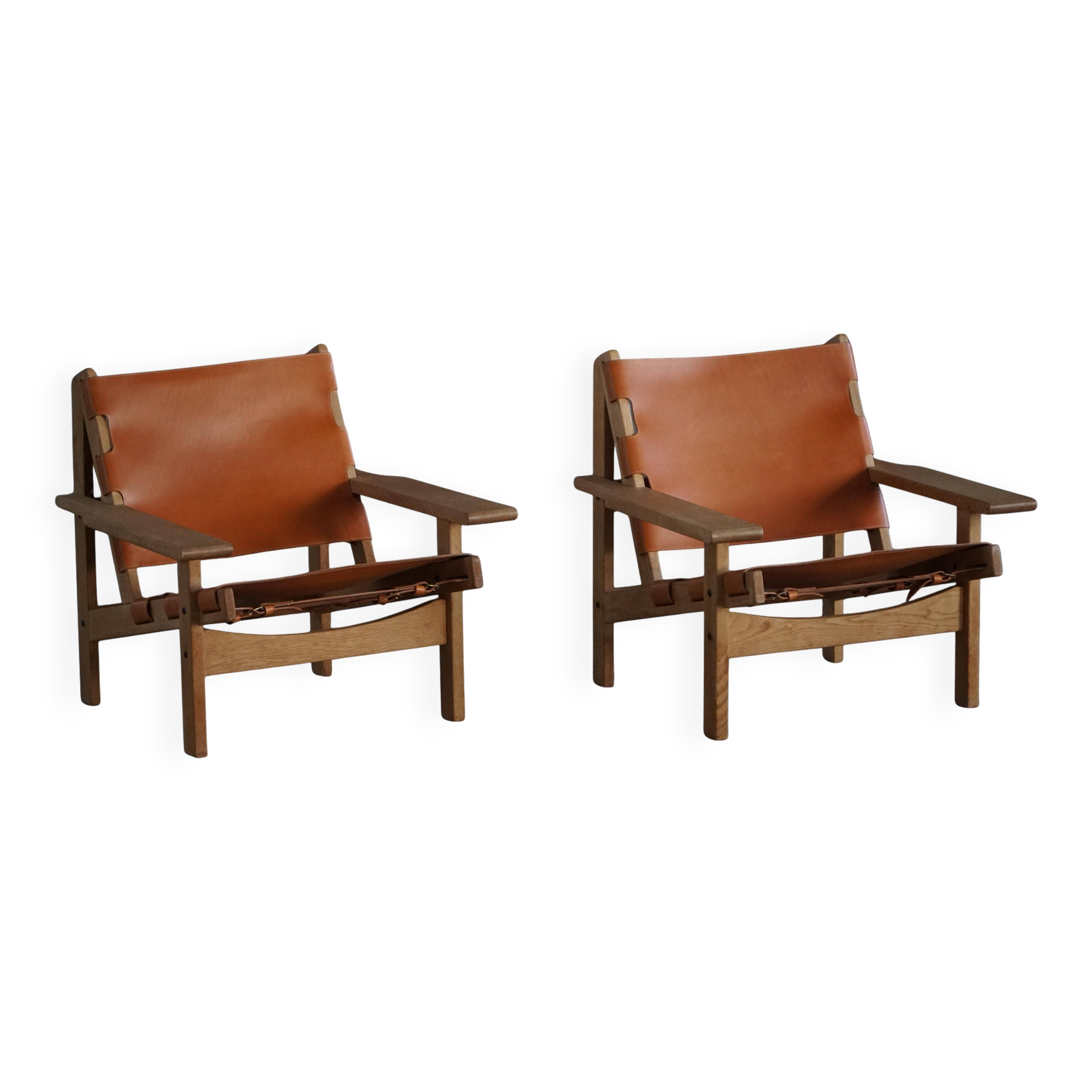 Pair of oak and leather hunting chairs by Kurt Østervig, modern Danish style from the 1960s.
