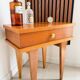 Vintage bedside table with tapered legs.
