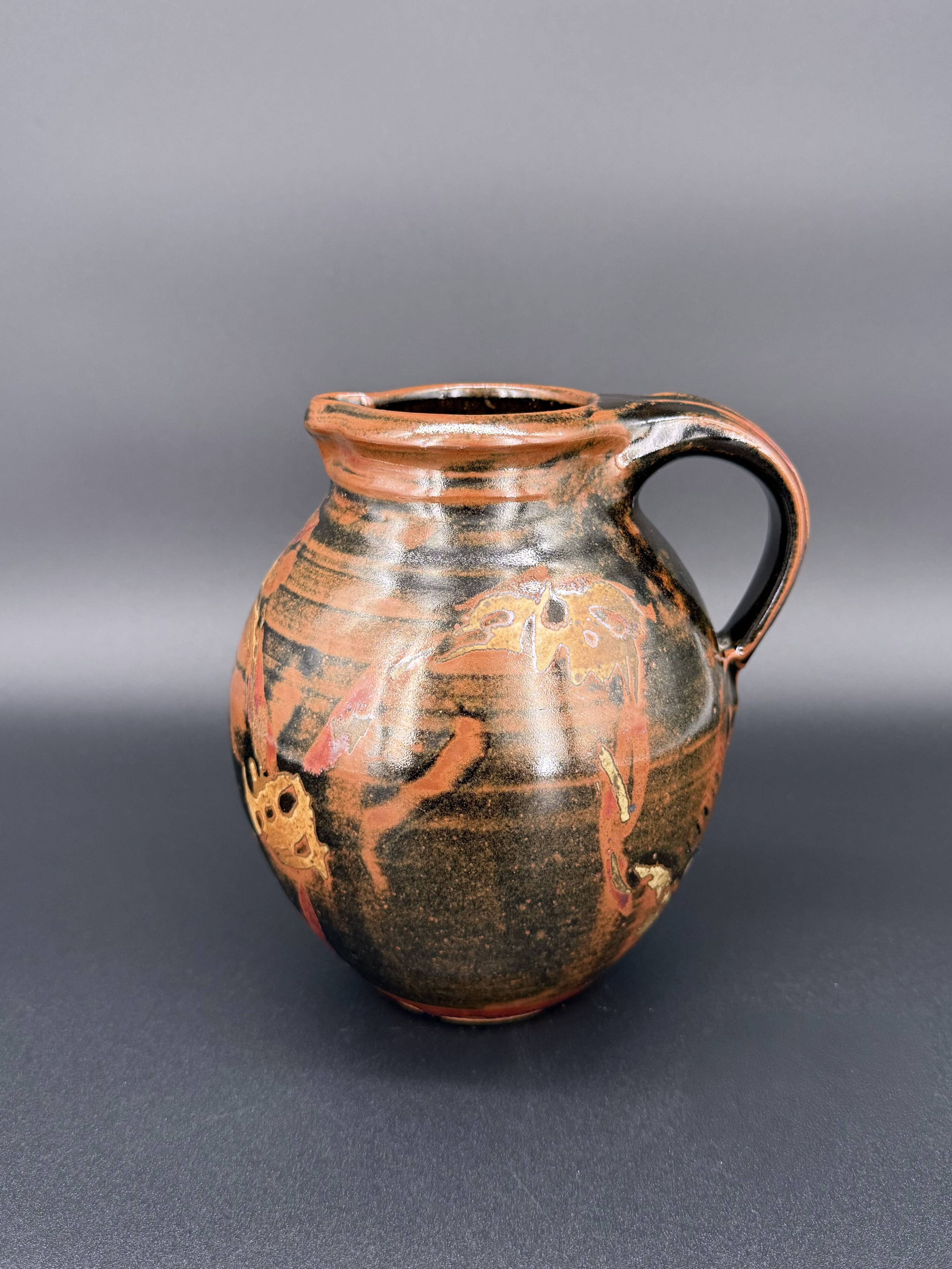 Signed black and red glazed stoneware pitcher, French artisanal ceramics